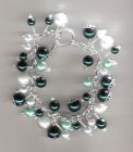Green and white charm style bracelet.