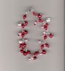 Red, pink and white charm style bracelet.