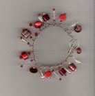 Red and clear bead charm style bracelet.